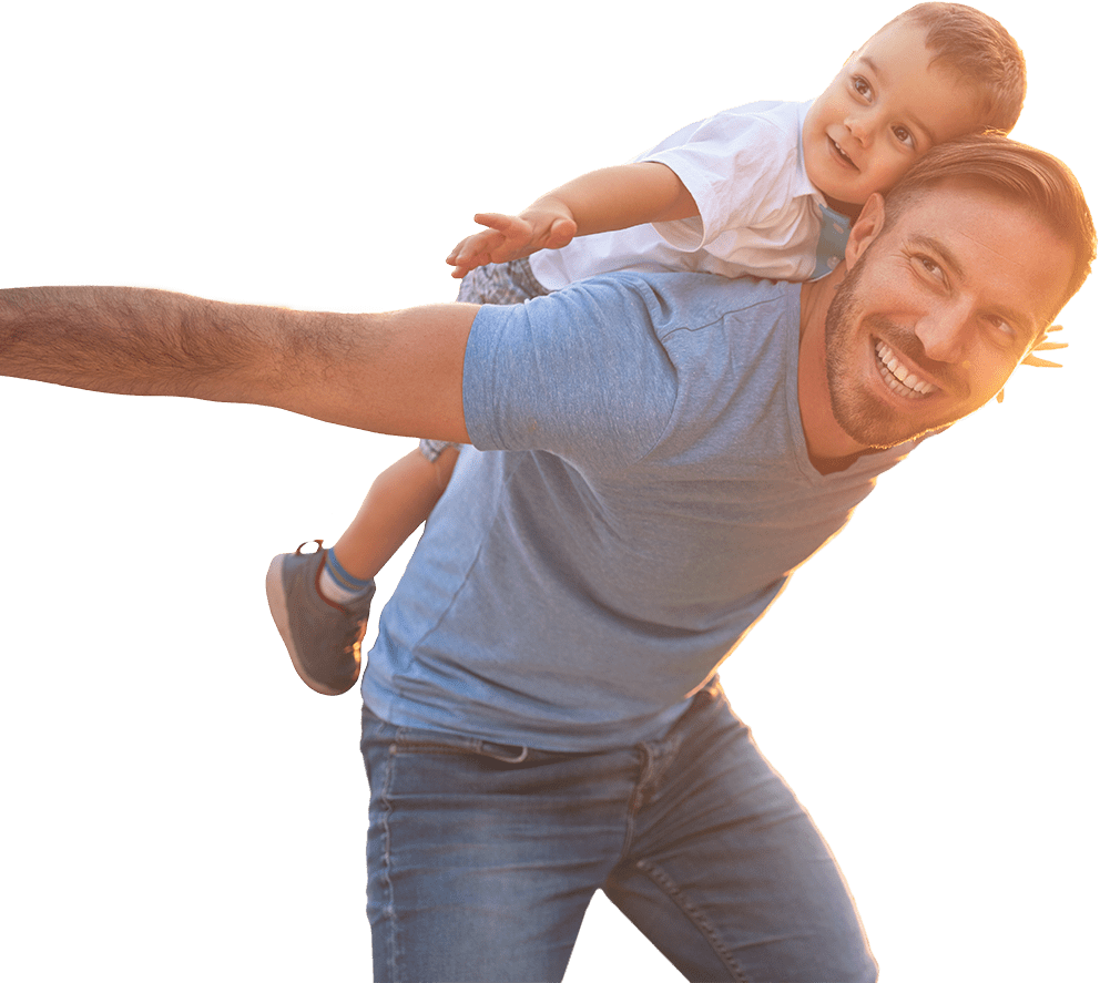 Father with young child on his back smiling