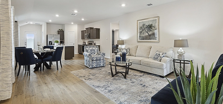 Open-concept living and dining area with modern furniture and bright natural light.