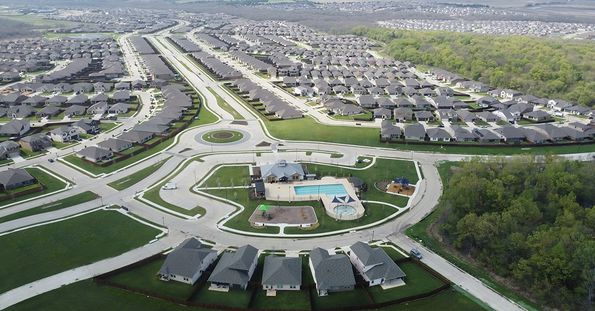 Aerial view of Wildcat Ranch master-planned community with homes, pool, and amenities in Crandall Texas