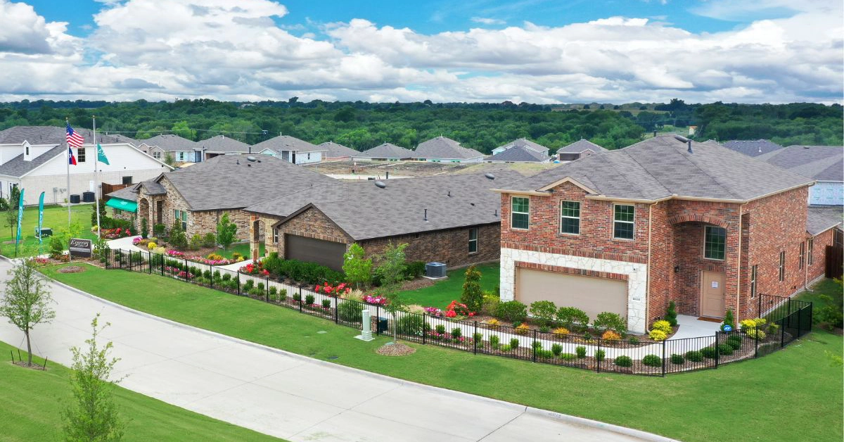 New construction homes and neighborhood streetscape in the Wildcat Ranch community in Crandall Texas