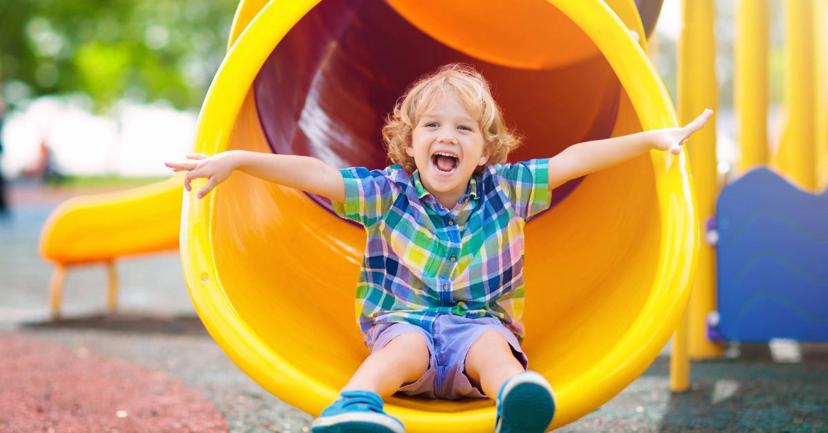 Child playing on a slide at the playground in the Wildcat Ranch community in Crandall Texas